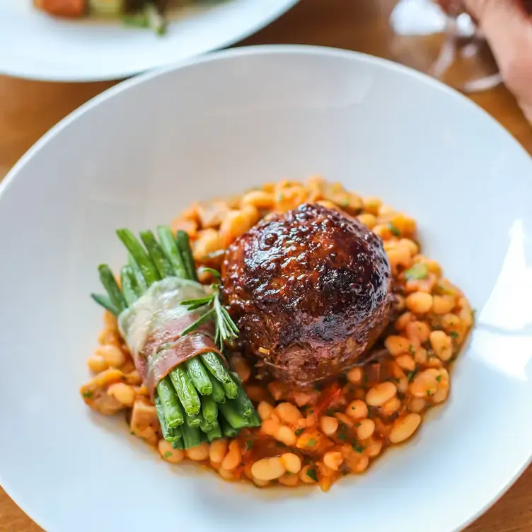 A duck and bean cassoulet with asparagus at La Garrigue, one of the best date night restaurants in Edinburgh.