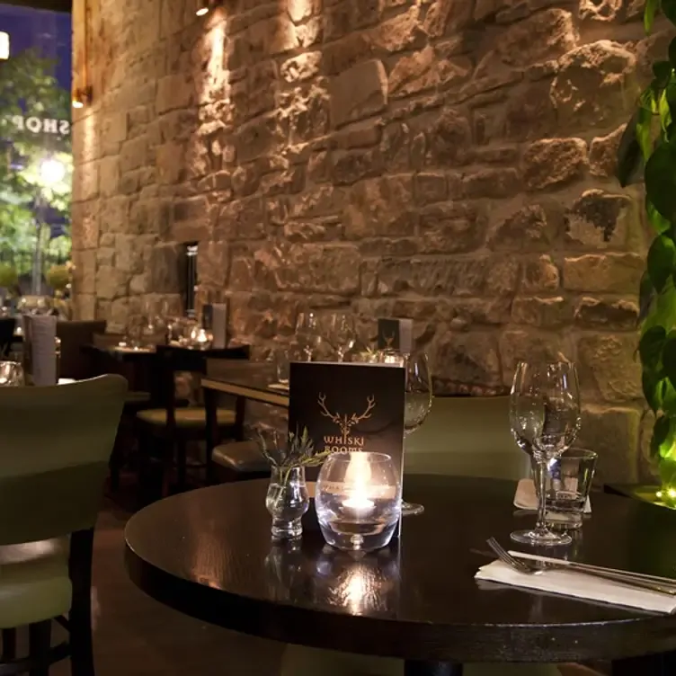 Dining room tables with menus at Whiski Rooms, one of Edinburgh’s best date restaurants.