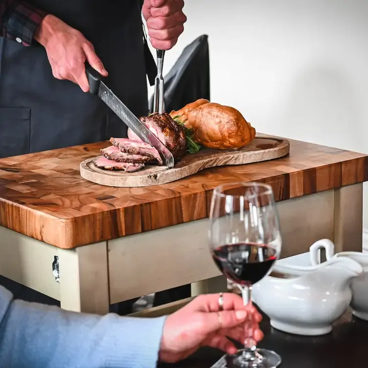 A server carving steak at Kyloe Gourmet Steak Restaurant, one of Edinburgh’s best date restaurants