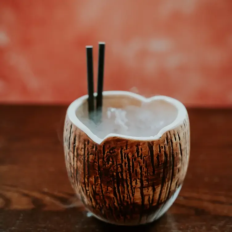 A cocktail in a coconut style glass at Siamais, one of the best romantic restaurants in Birmingham.