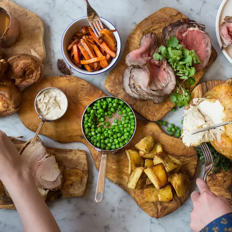 A sharing platter of steak, peas, and potatoes at Copper Blossom