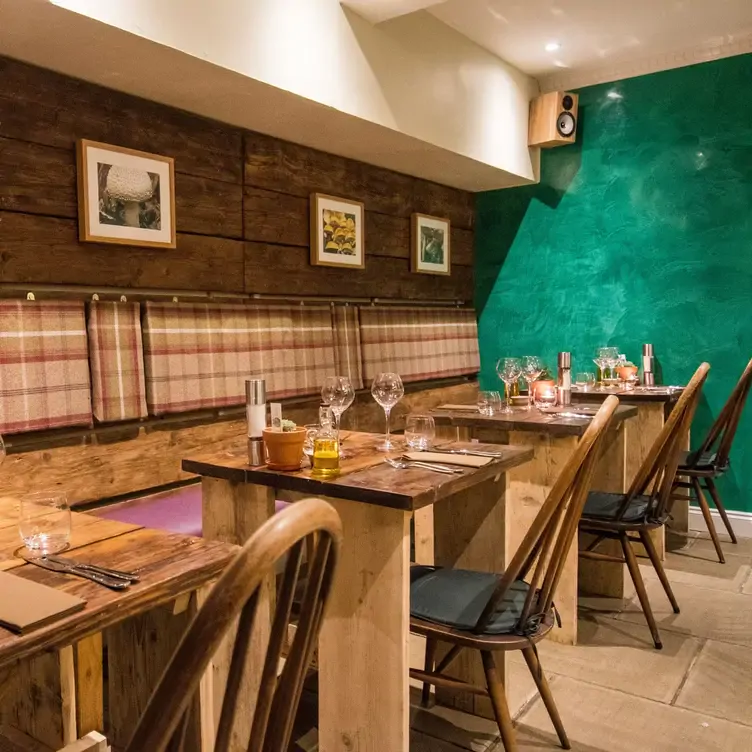 Wooden tables in the dining room at Forage and Chatter, one of the most romantic restaurants in Edinburgh.