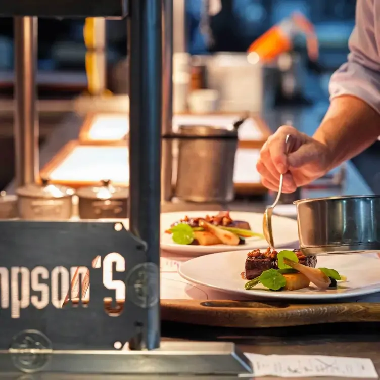 A chef applies sauce to a dish at Simpsons, one of the best romantic restaurants in Birmingham.