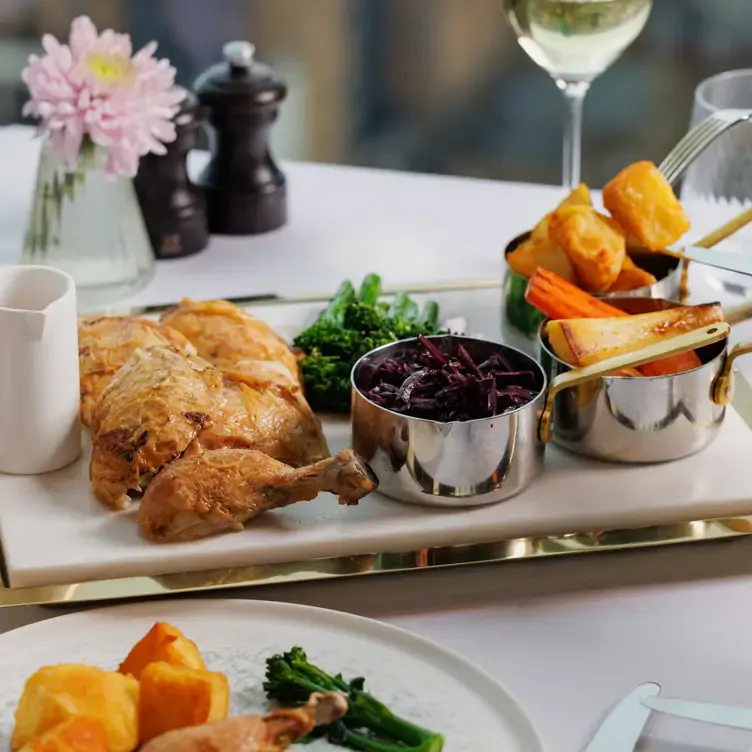 A dish of roasted chicken with braised leg cabbage, roast potato, and jus gras at Orelle Birmingham, one of the top romantic restaurants in Birmingham.