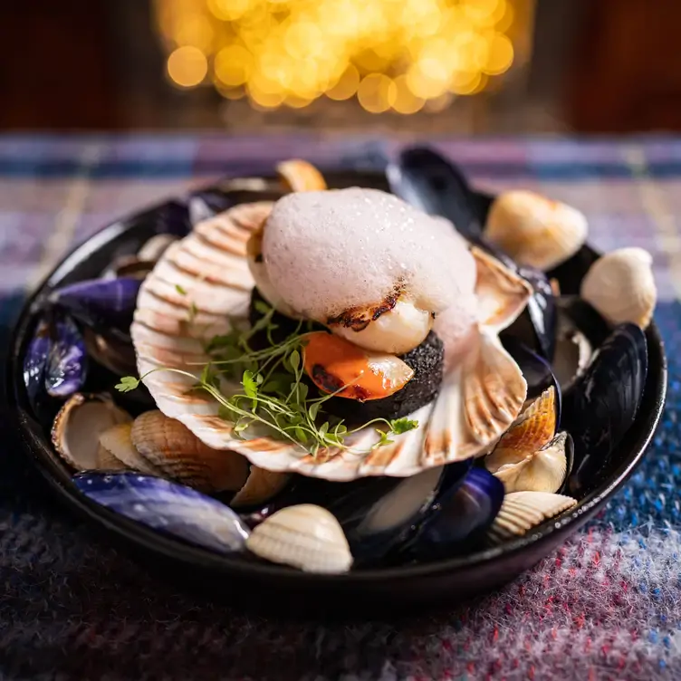 A scallop with black pudding in a scallop shell at No11, one of the most romantic restaurants in Edinburgh.