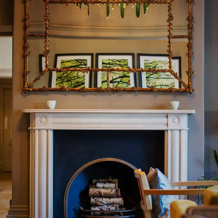 A fireplace and decorative mirror inside Simpsons, one of the best romantic restaurants in Birmingham.