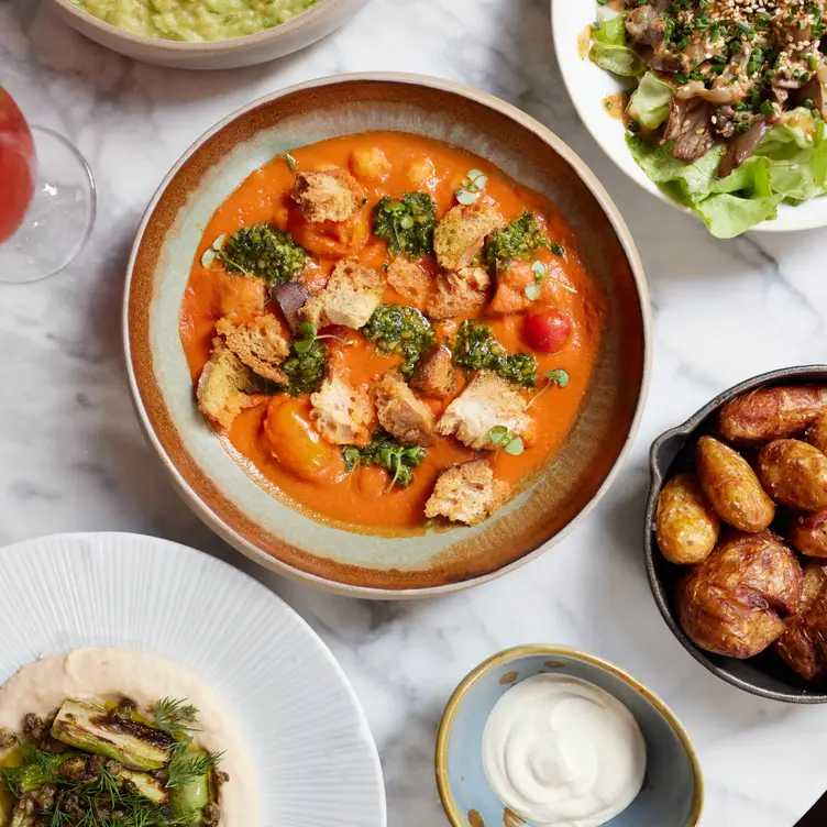 A spread of plant-based dishes at Plants by Deliciously Ella, one of the best vegan restaurants in London