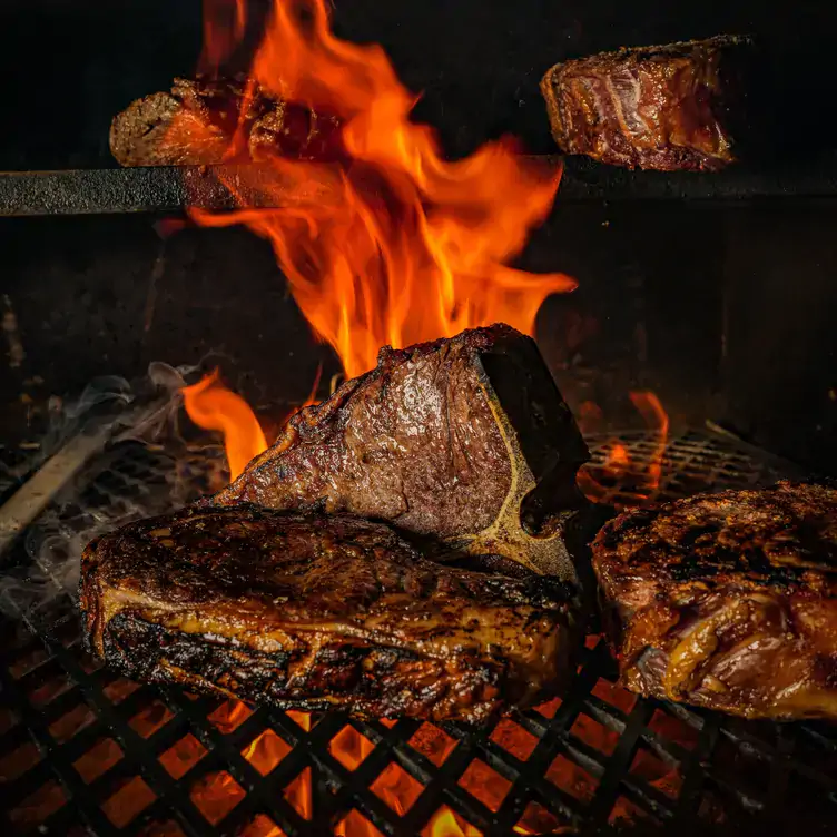 Steaks are cooked on an open flame at Hawksmoor, one of the most sustainable restaurants in London and the UK