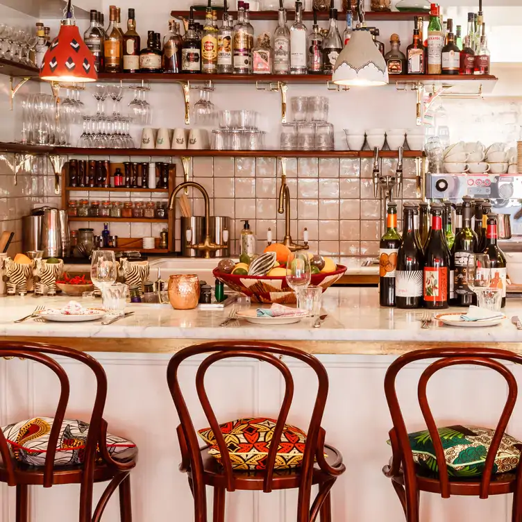 Three plates of Scotch eggs sit on a wooden table at Jikoni, one of the most sustainable restaurants in the UK