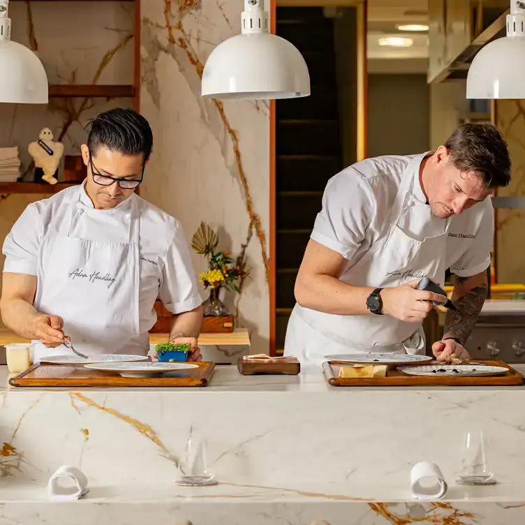 Chef Adam Handling and his team prepare dishes from the open kitchen at Frog by Adam Handling, one of the best fine dining restaurants in London