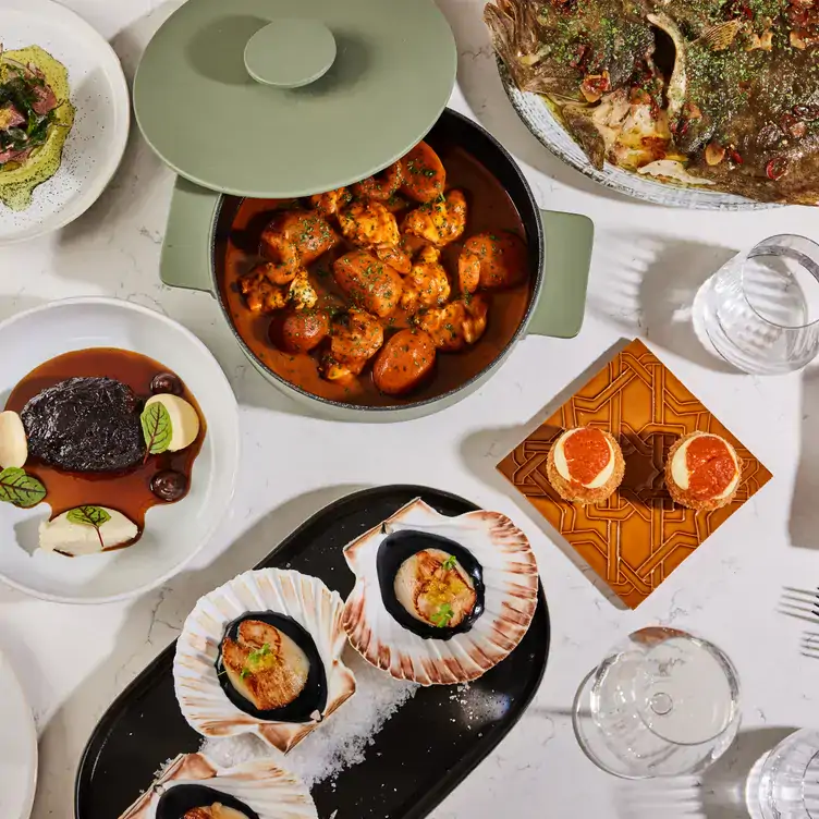 50713856A spread of Portuguese-inspired dishes featuring scallops, dish and croquettes at JOIA Restaurant & Bar Battersea, one of the best rooftops in London