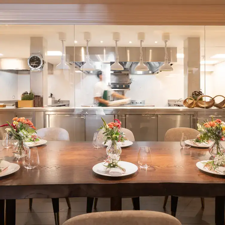 A table sits in front of an open-kitchen at CORE by Clare Smyth, a restaurant in London