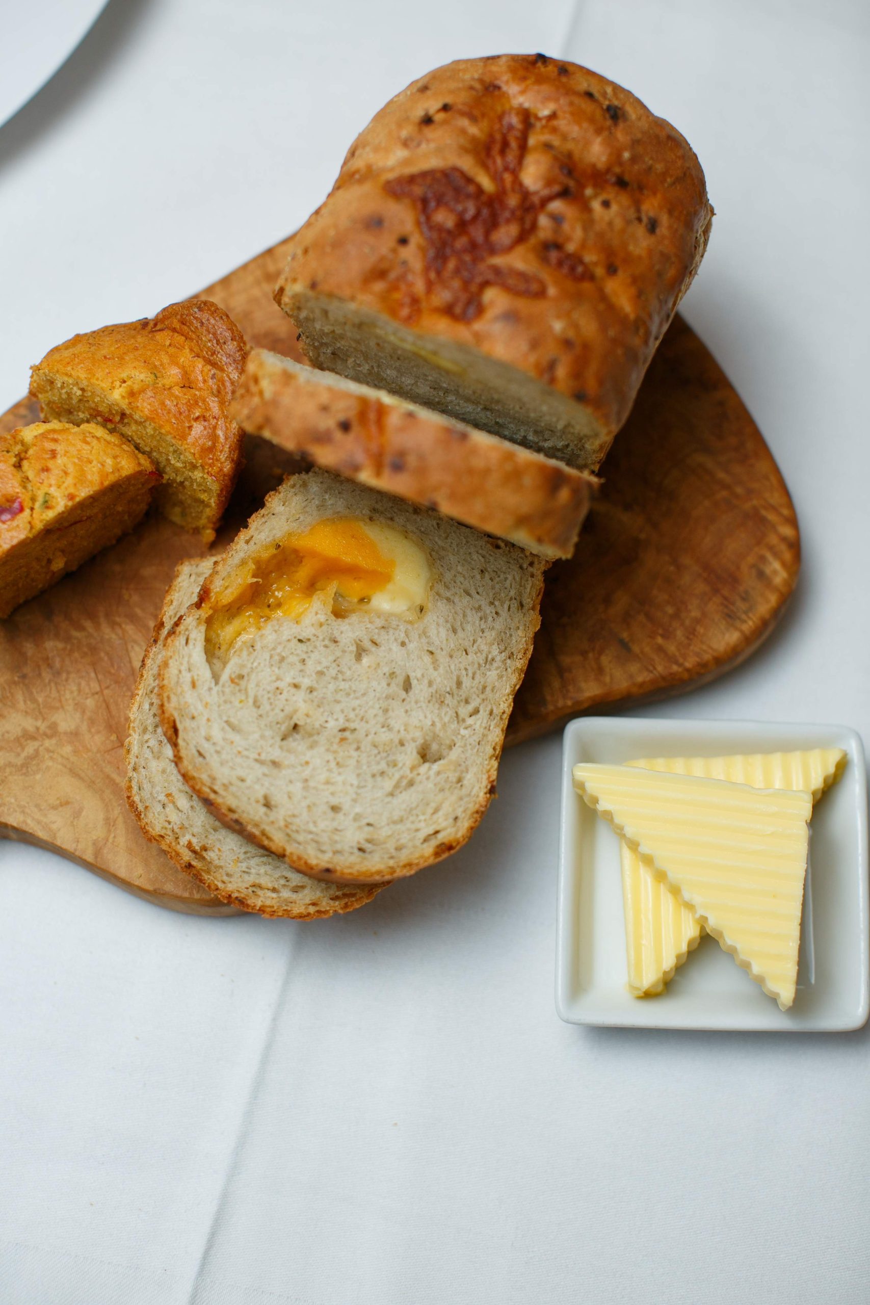 Slices of bread and a spread of butter presented on a wooden board at Shanahan's on the Green, a restaurant in Dublin.