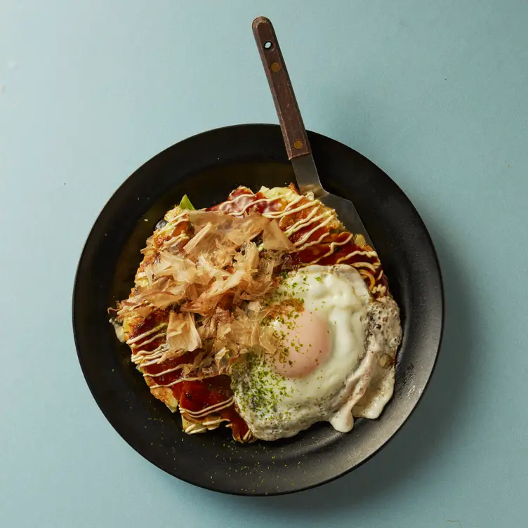 Okonomiyaki pancakes with an egg at Okan, one of the best Japanese restaurants in London.