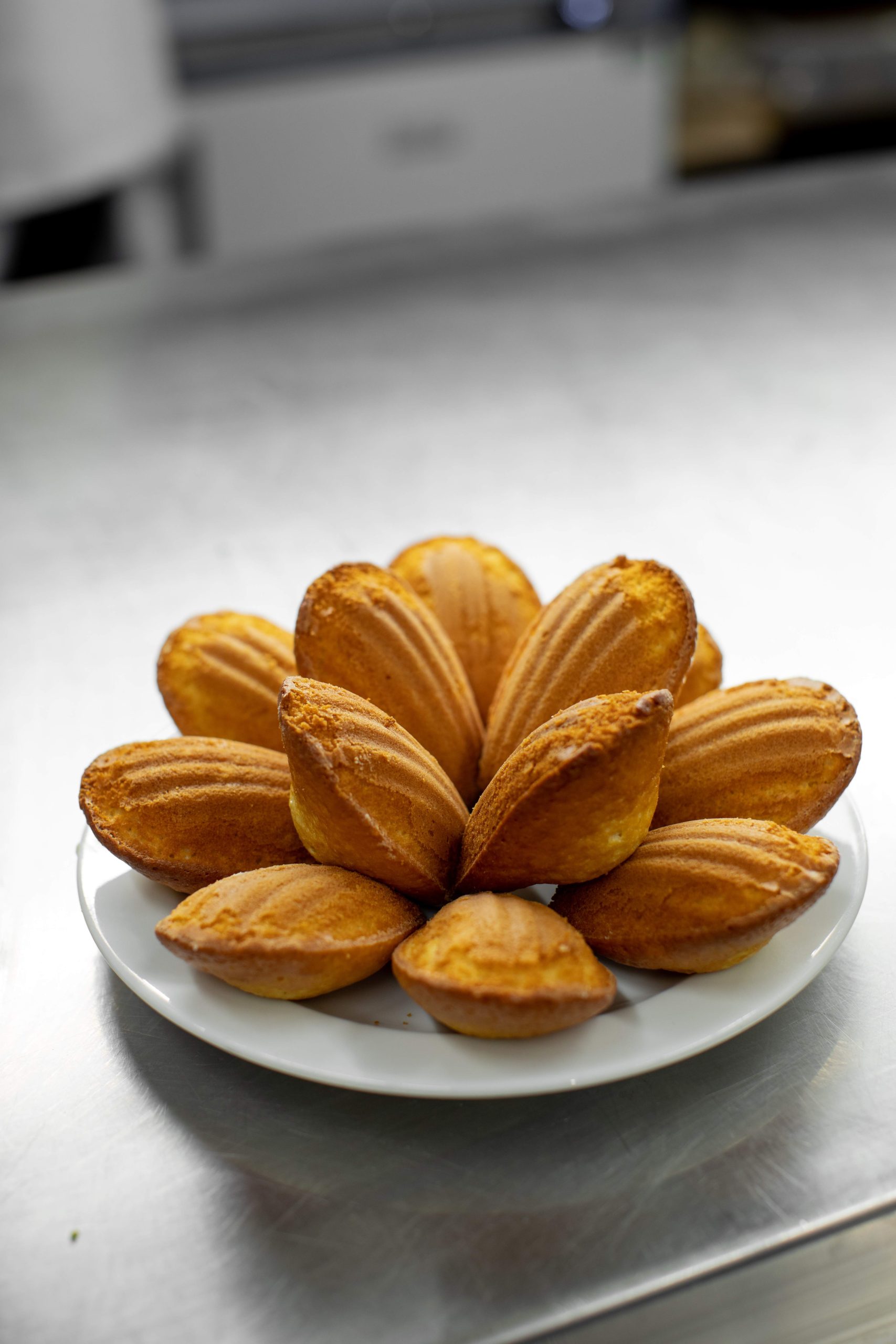 A group of madeleines are arranged in a floral shape at St. JOHN, a restaurant in London.