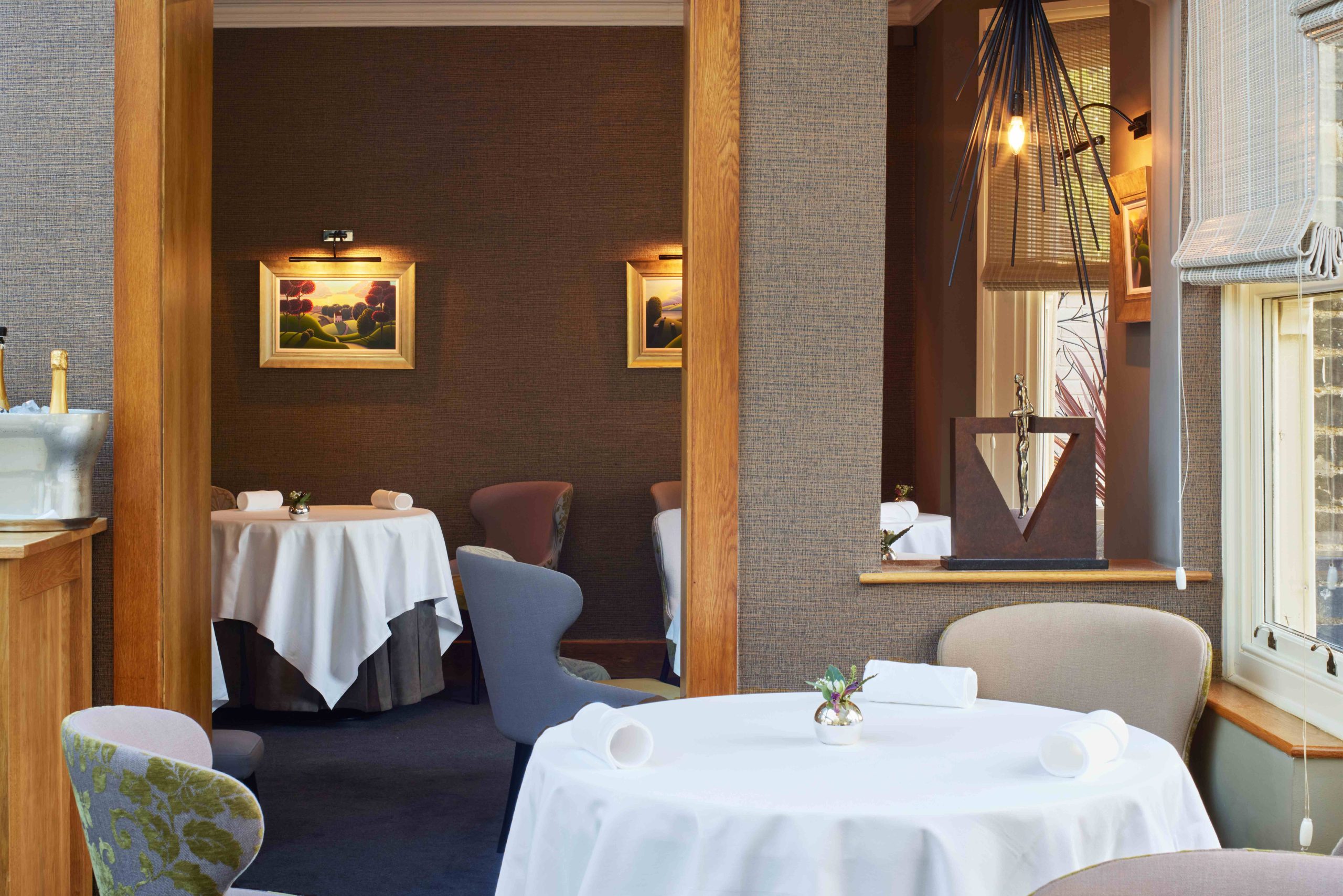 White cloths drape the circular dining tables at Midsummer House Restaurant in Cambridge.