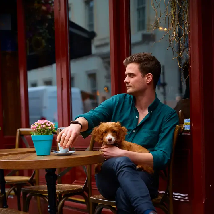 A diner and his dog at Forty Dean Street, one of the best pet-friendly restaurants in London