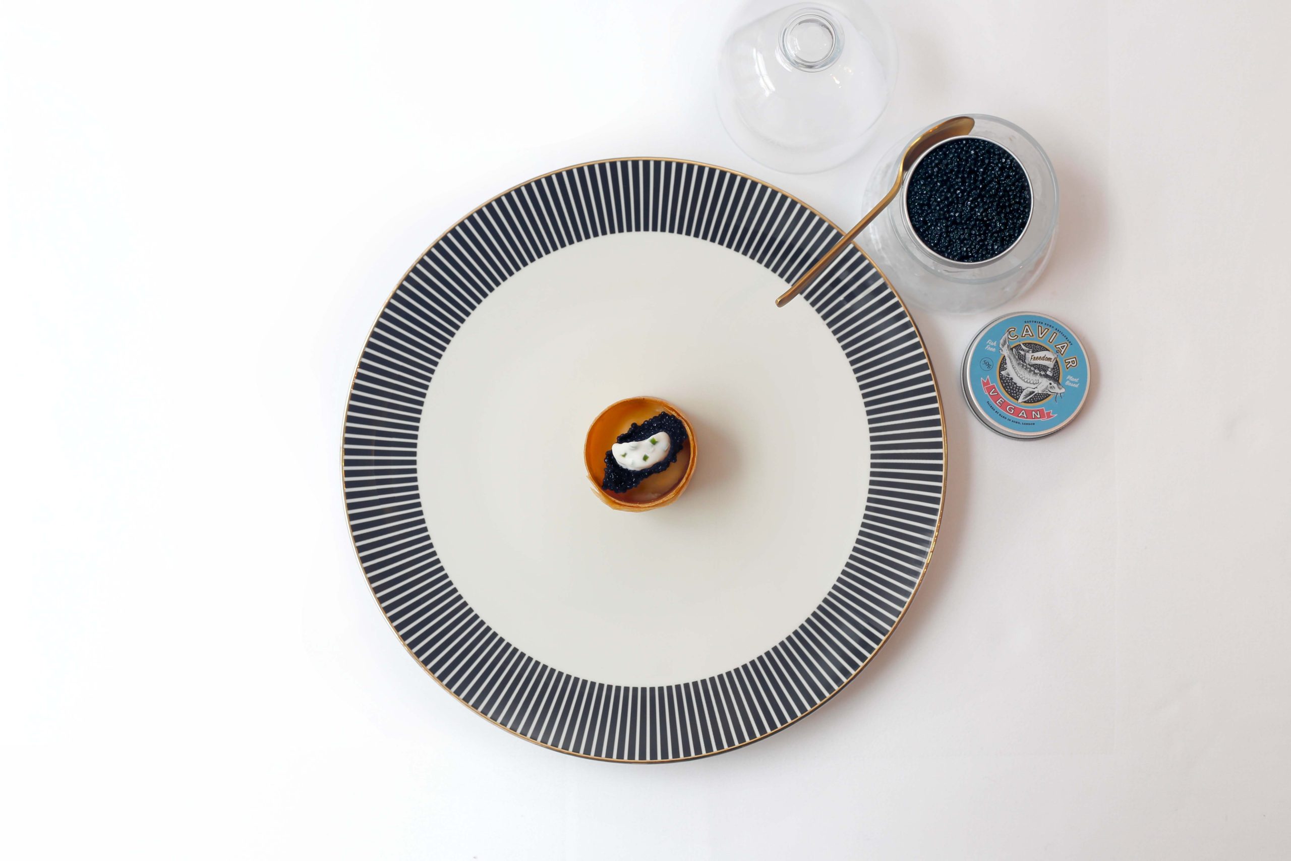 An amuse-bouche with plant-based caviar sits on a plate with geometric patterns at Gauthier Soho, a restaurant in London.