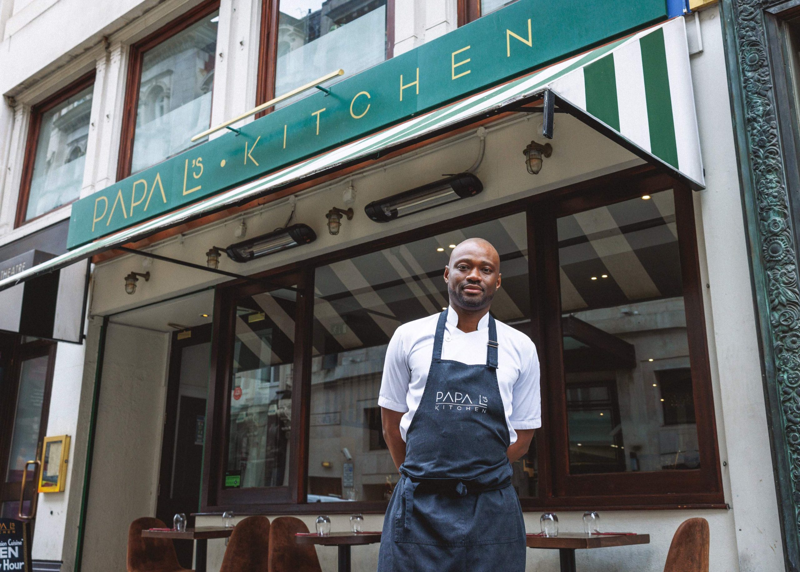 Chef Lawrence Gomez stands in front of his restaurant Papa L’s Kitchen in London.