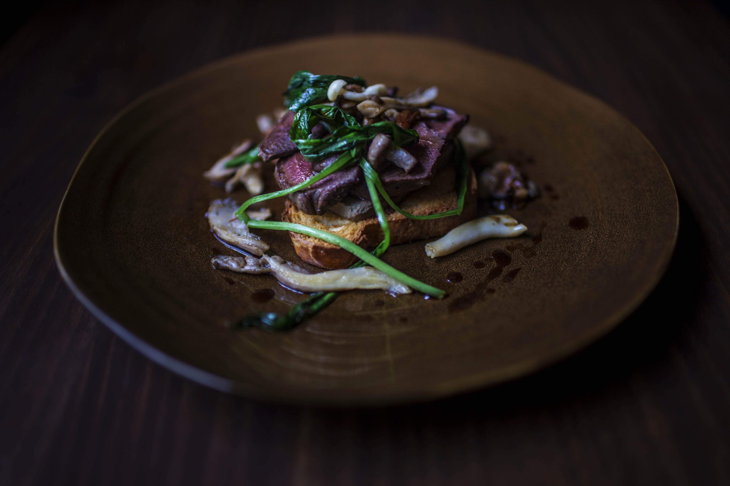 Wood pigeon sits on top of toast with seasonal greens at Camden Kitchen, a restaurant in Dublin