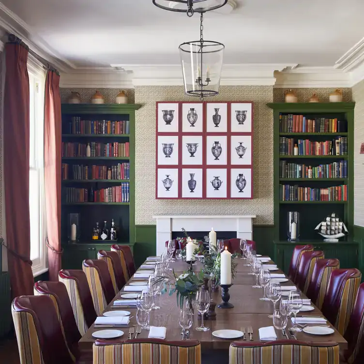 A long table set for dining in a private room at The Surprise Chelsea, one of the best restaurants for Christmas in London.