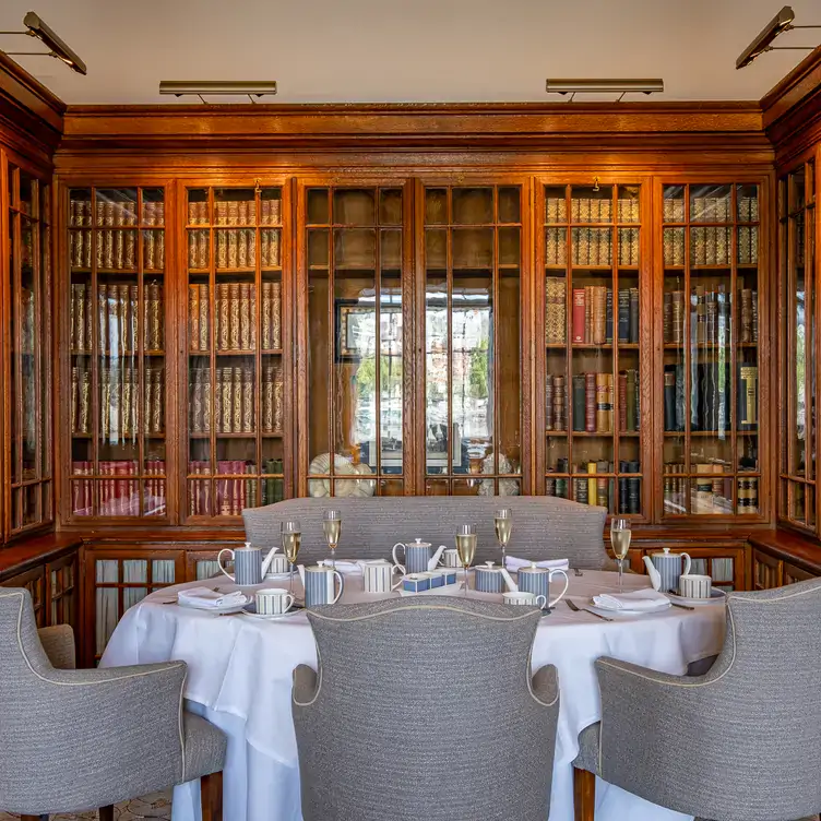 A private room at The Library at County Hall, one of the best restaurants for Christmas in London, with bookshelves surrounding a table set for dining.