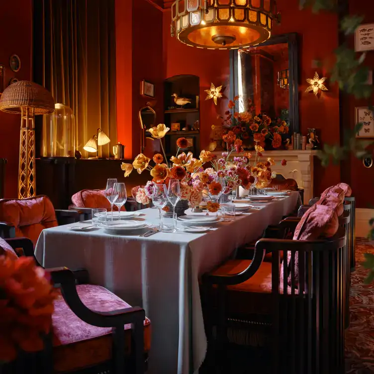 A table set with floral arrangements in a private dining room at The Midland Grand Dining Room, one of the best Christmas restaurants in London.