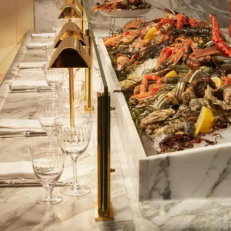 An iced raw bar filled with seafood including lobsters at Louie, one of the best Christmas restaurants in London.