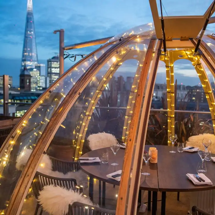 An igloo on the rooftop of Mercer Roof Terrace Igloos, one of the best Christmas restaurants in London, with views across London.