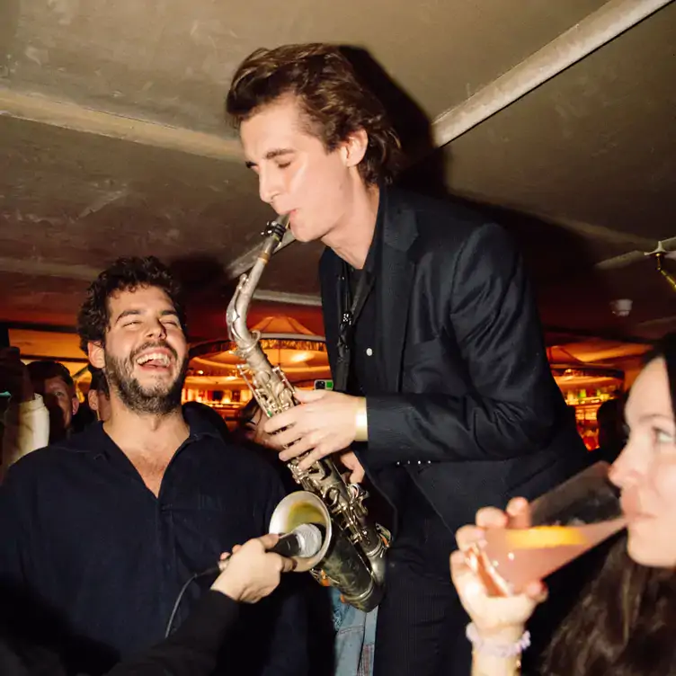 A jazz musician playing the saxophone at Louie, one of the best London Christmas restaurants.