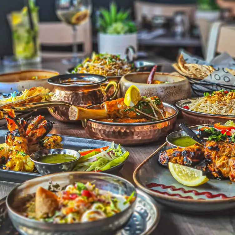 Main dishes accompanied by side dishes on a table at Jajoo, one of the best Indian restaurants in Manchester. Credit: Jajoo Indian Street Food