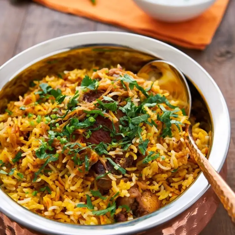 A bowl of Chicken Biryani with a dash of coriander at Khandoker - Didsbury, one of the best Indian restaurants in Manchester. Credit: Khandoker - Didsbury