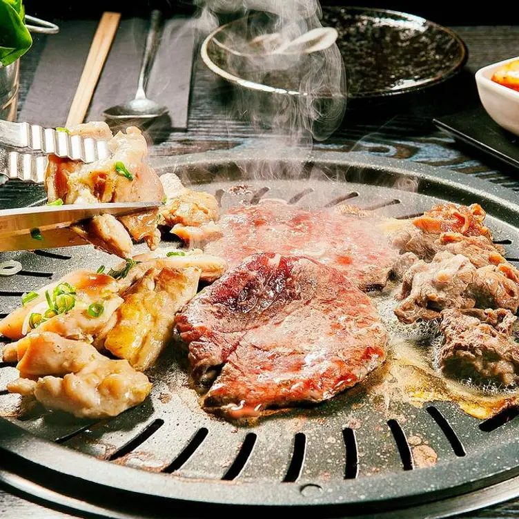 A selection of meats on the grill at Bullgogi, one of the best Korean restaurants in London.