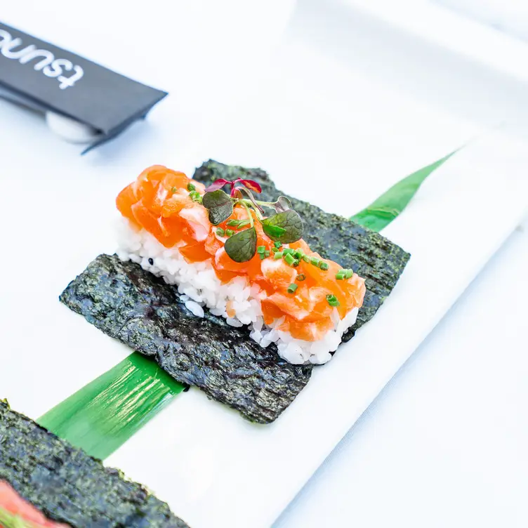 A salmon and rice sushi roll laid out on seaweed at Tsunami - Clapham, one of the best sushi restaurants in London.