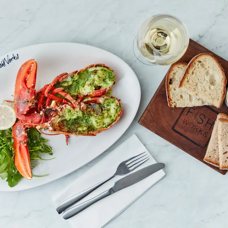 A lobster dish on a marble top with a side of bread at Fishworks - Covent Garden, one of the best seafood restaurants in London.