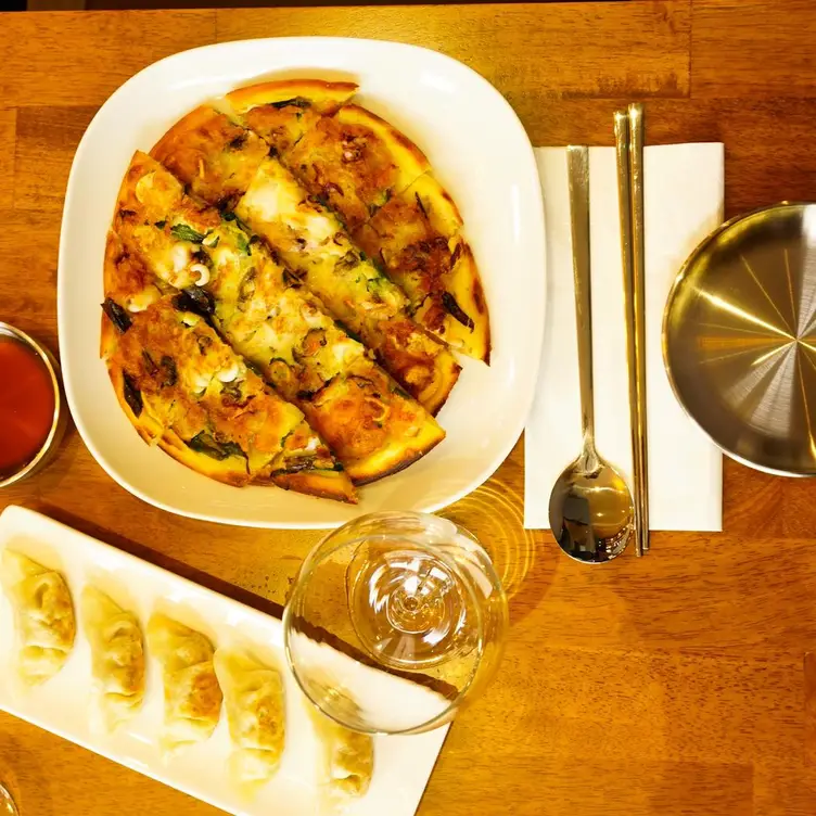 Starters including dumplings and pizza at Cho Sim, one of the best Korean restaurants in London.