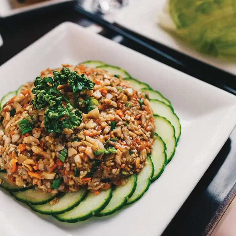 A mix of vegetables, legumes and meat, presented with care on a bed of cucumber at Pacifica Cantonese, one of the best Chinese restaurants in Manchester.