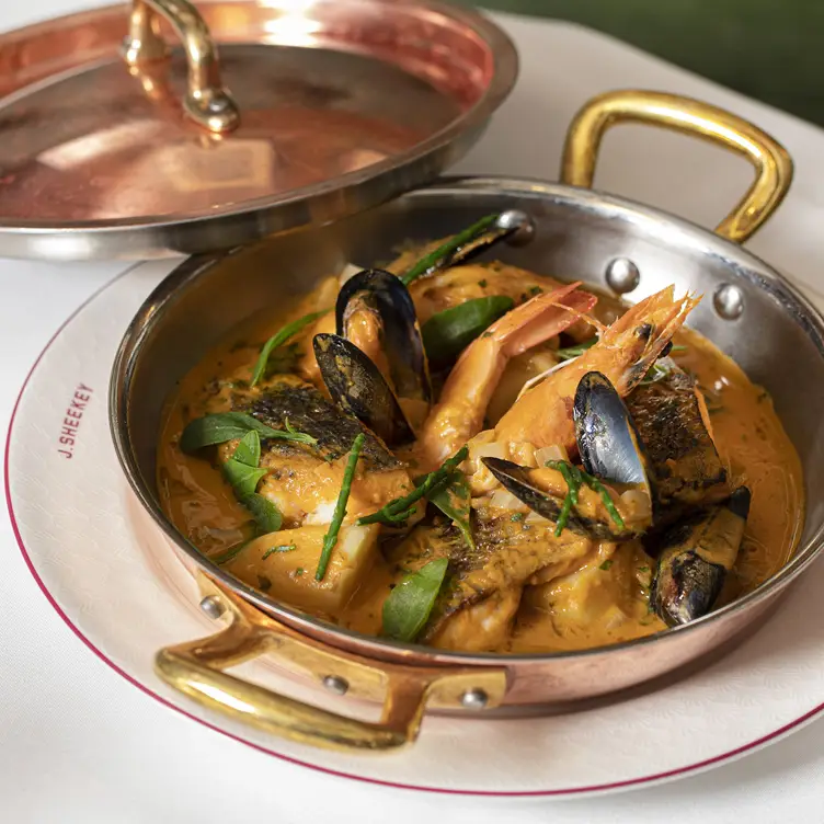 A plate of fish, prawns and mussels in a creamy sauce at J Sheekey - The Restaurant.