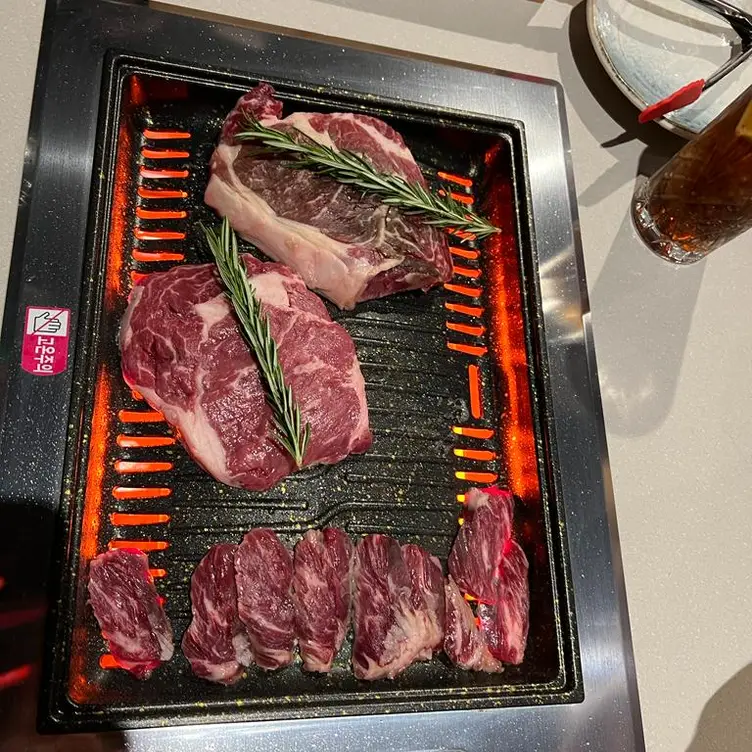 Seasoned meat on the grill at Korean BBQ & Vegan Restaurant, one of the best Korean BBQ restaurants in London.