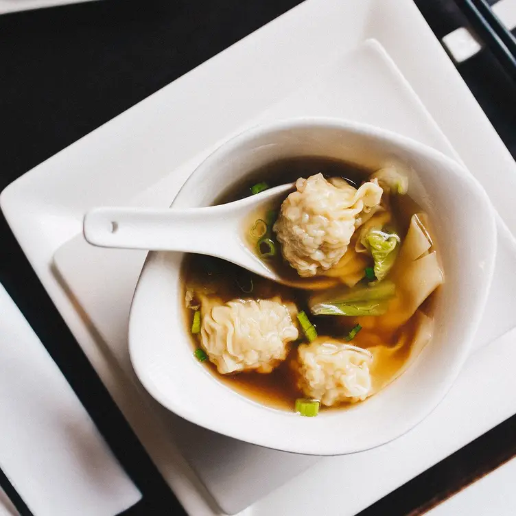 A bowl of soup with dumplings at Pacifica Cantonese, one of the best Chinese restaurants in Manchester.