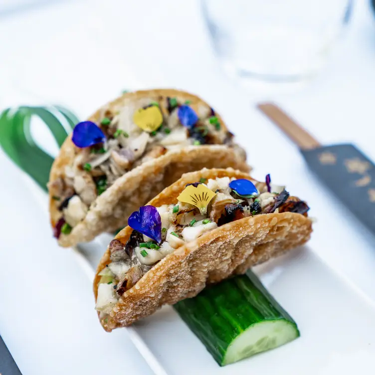 A sushi garnished inside a crispy taco-shaped crust at Tsunami - Clapham, one of the best sushi restaurants in London.