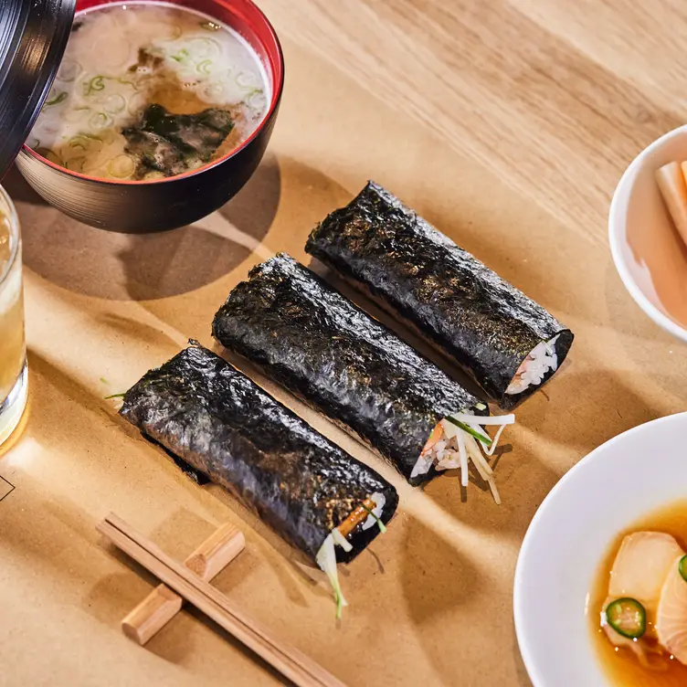 A plate of traditional sushi sits on a table accompanied by a miso soup at TEMAKI, one of the best sushi restaurants in London.