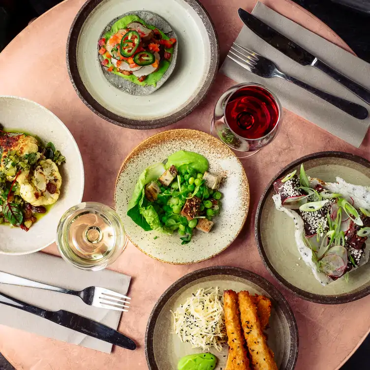 Various vegan and vegetarian dishes on a table at Tendril, one of the best vegetarian restaurants in London.