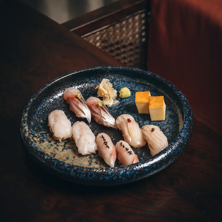 A selection of sushi on a shallow bowl with wasabi and ginger at The Aubrey @ Mandarin Hotel, one of the best sushi restaurants in London.