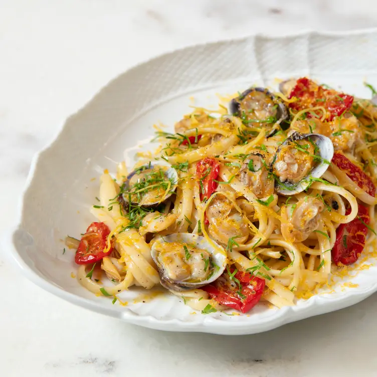 A dish of seafood linguine with grated cheese and tomatoes at Gattopardo in London.