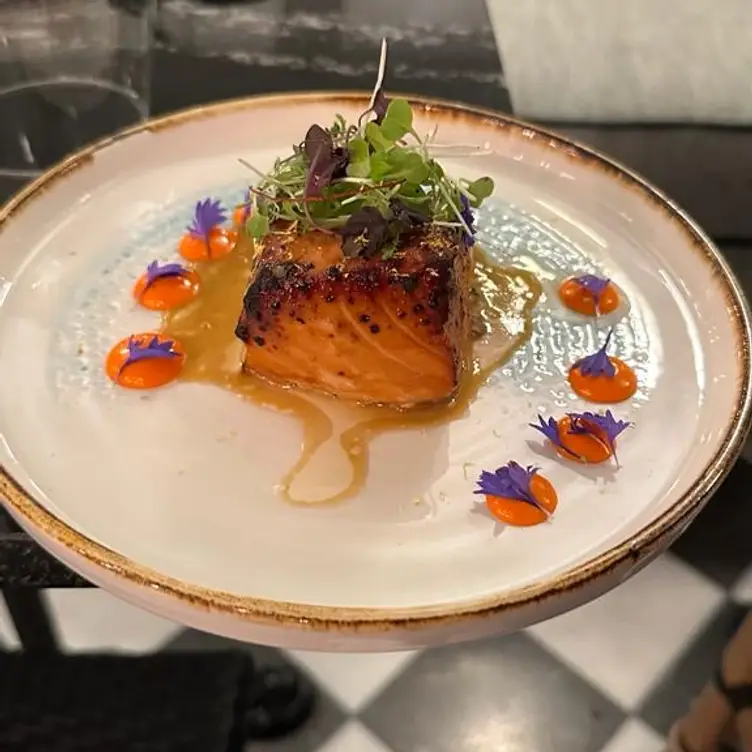 A plate of seared salmon with colourful garnish at 103 Parkway, one of the best sushi restaurants in London.