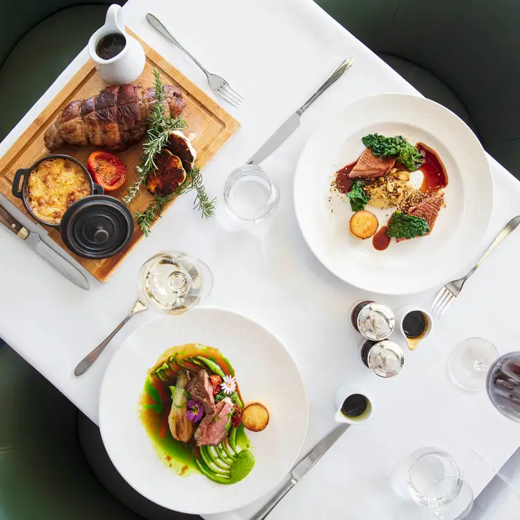 A table set with food at Coq d’Argent, one of the best French restaurants in London.