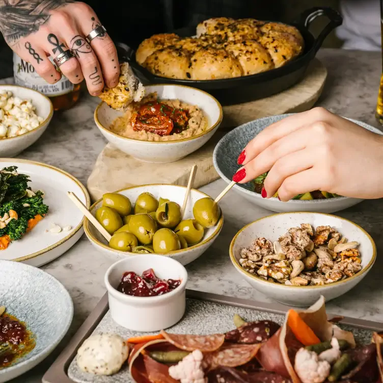 Two people share a number of small plates at Champagne Central, in Glasgow.