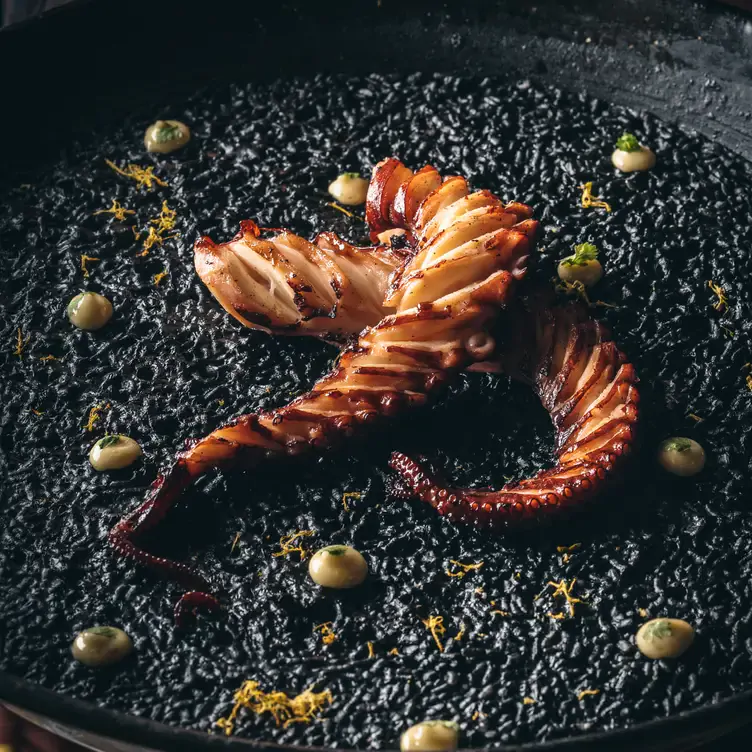 A black paella featuring grilled octopus at BiBo by Dani Garcia, one of the best Spanish restaurants in London.