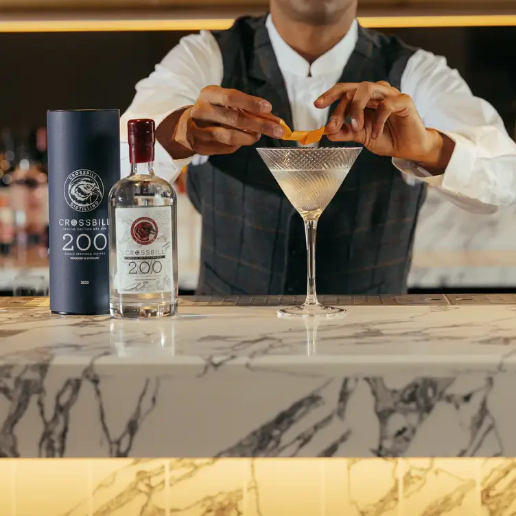 A bartender prepares a cocktail at The Hazel, one of the best romantic restaurants in Glasgow.